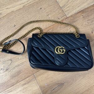 Black quilted leather crossbody with gold metal chain